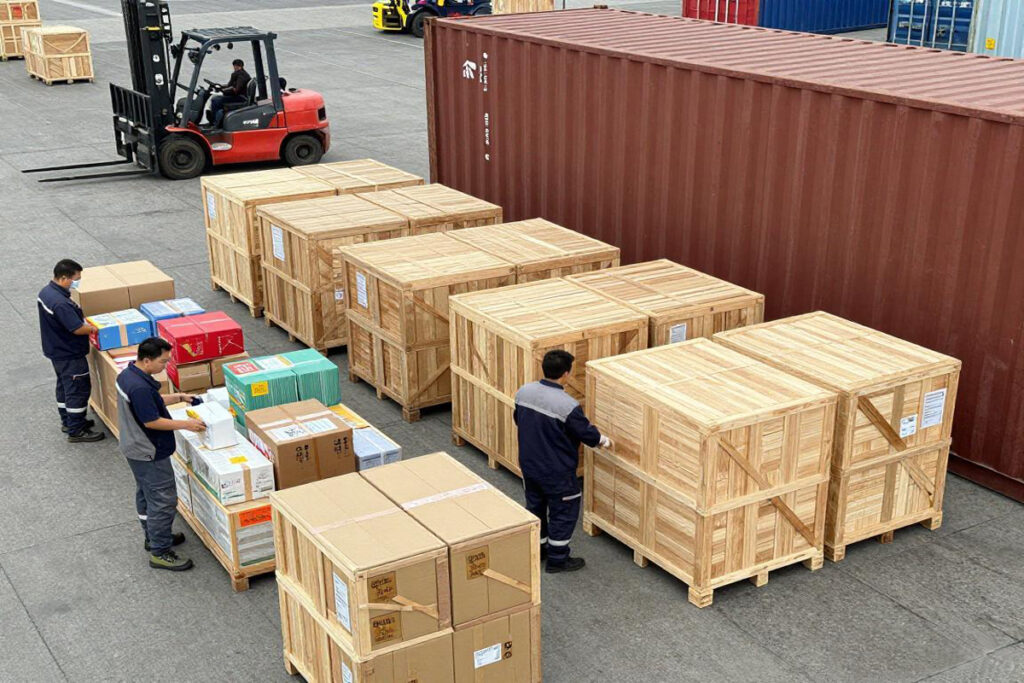 Building materials being loaded into a shipping container for export from China